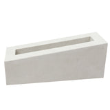 The Corsi Sample by New York Cement Tile is a white, rectangular breeze block with one slanted side on a plain background.