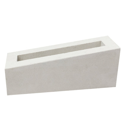 The Corsica Rectangular, Extra Sample by New York Cement Tile is a white, hollow block with one sloped side for partitions.