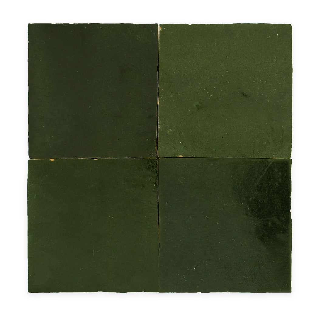 Four dark green square tiles arranged in a grid against a white background.