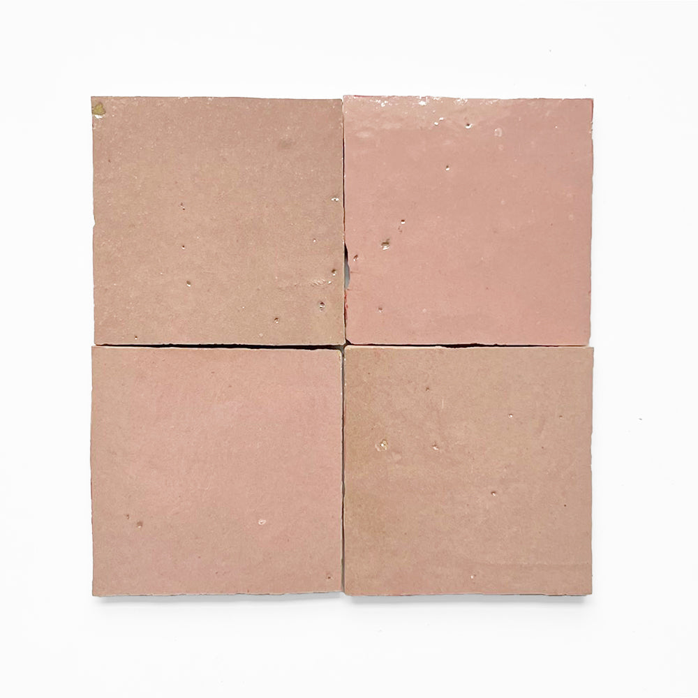 Four Warm Peach tiles by New York Cement Tile, pale pink and handcrafted, arranged in a grid on white.