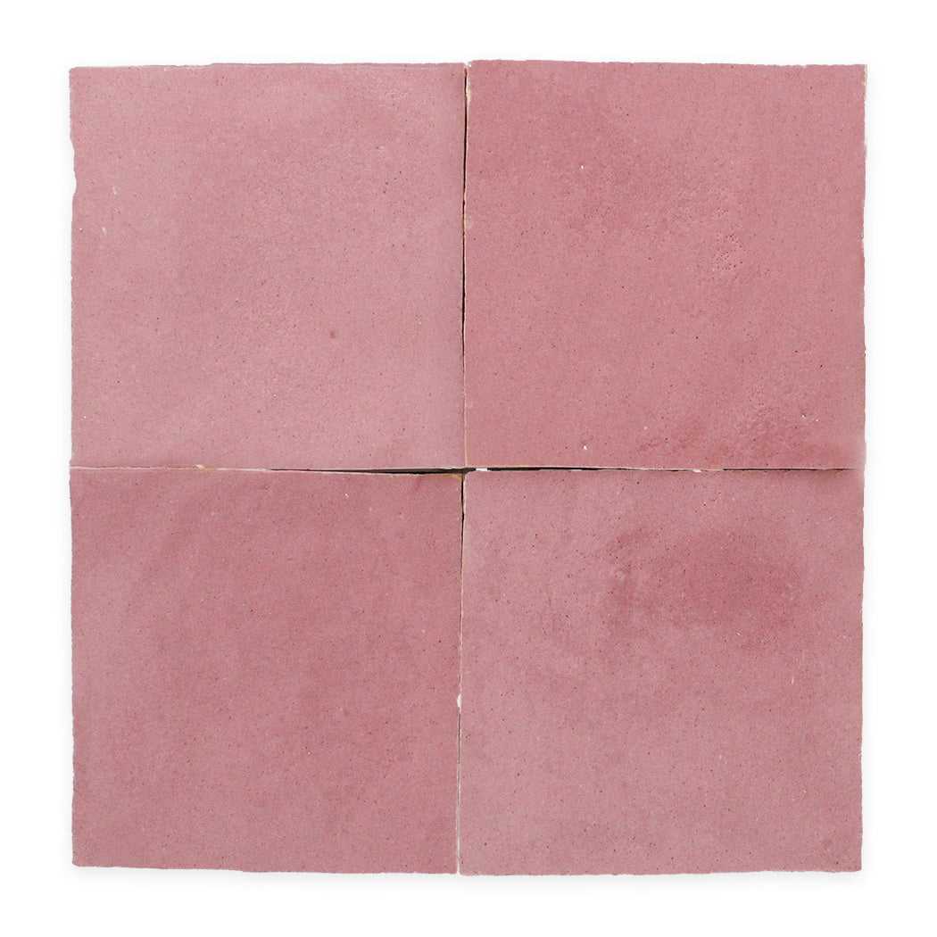 Four square, pink tiles arranged in a grid on a white background, with visible seams between each tile.