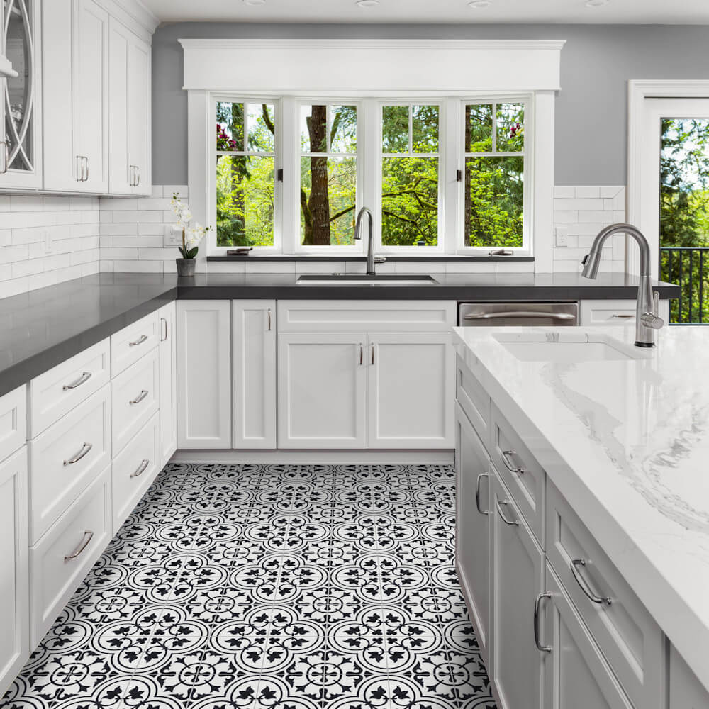 Modern kitchen featuring New York Cement Tile N20-045 White with gray counters and large windows overlooking greenery.