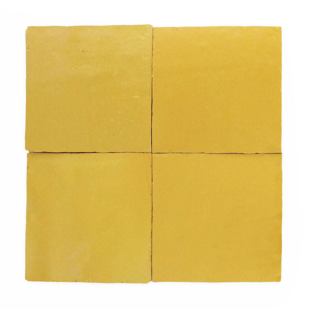 Four Sunflower Yellow Extra Sample tiles by New York Cement Tile arranged in a 2x2 grid on a white background.