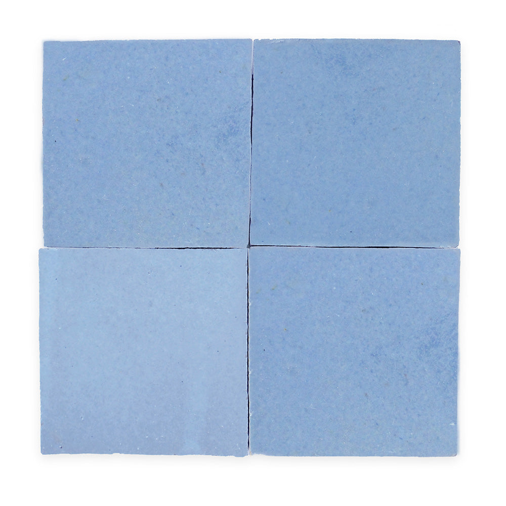 Four light blue square tiles arranged in a 2x2 grid with small gaps between them on a white background.