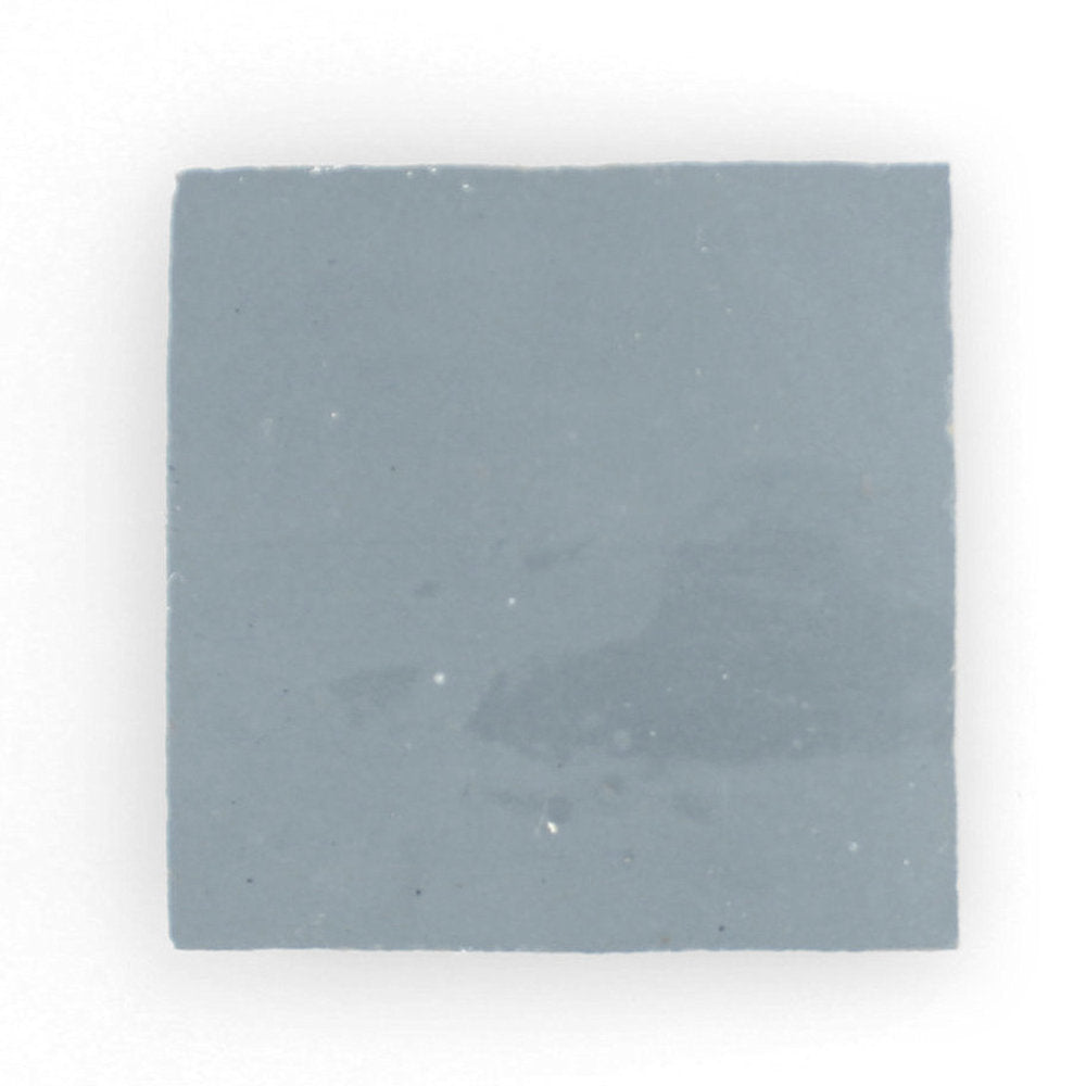 The Steel Grey 2X2 sample by New York Cement Tile is a handcrafted square Zellige tile in muted greyish-blue on white.