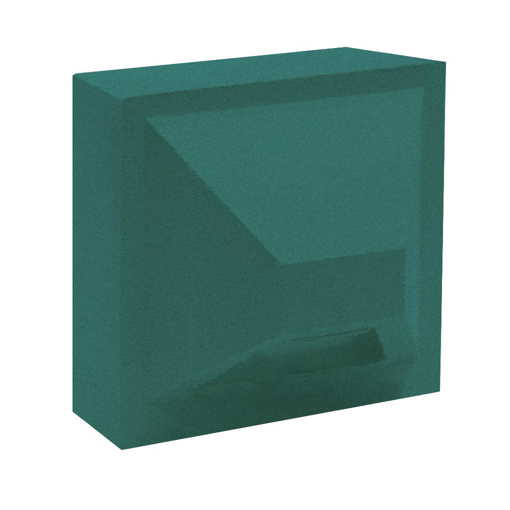 The Hawa Sample by New York Cement Tile is a teal glass block with beveled edges and a geometric indentation.