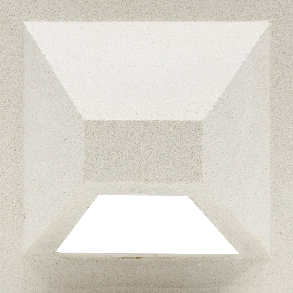 The Hawaii, Extra Sample by New York Cement Tile features geometric pyramid angles and sharp shadows on a white privacy wall.