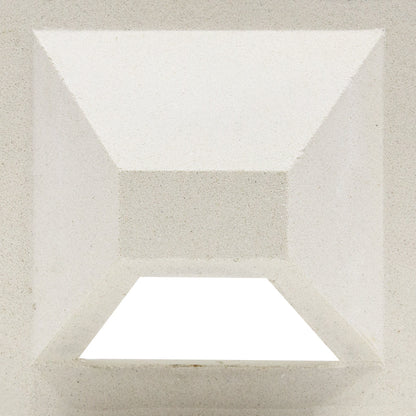 The Hawaii, Extra Sample by New York Cement Tile features geometric pyramid angles and sharp shadows on a white privacy wall.