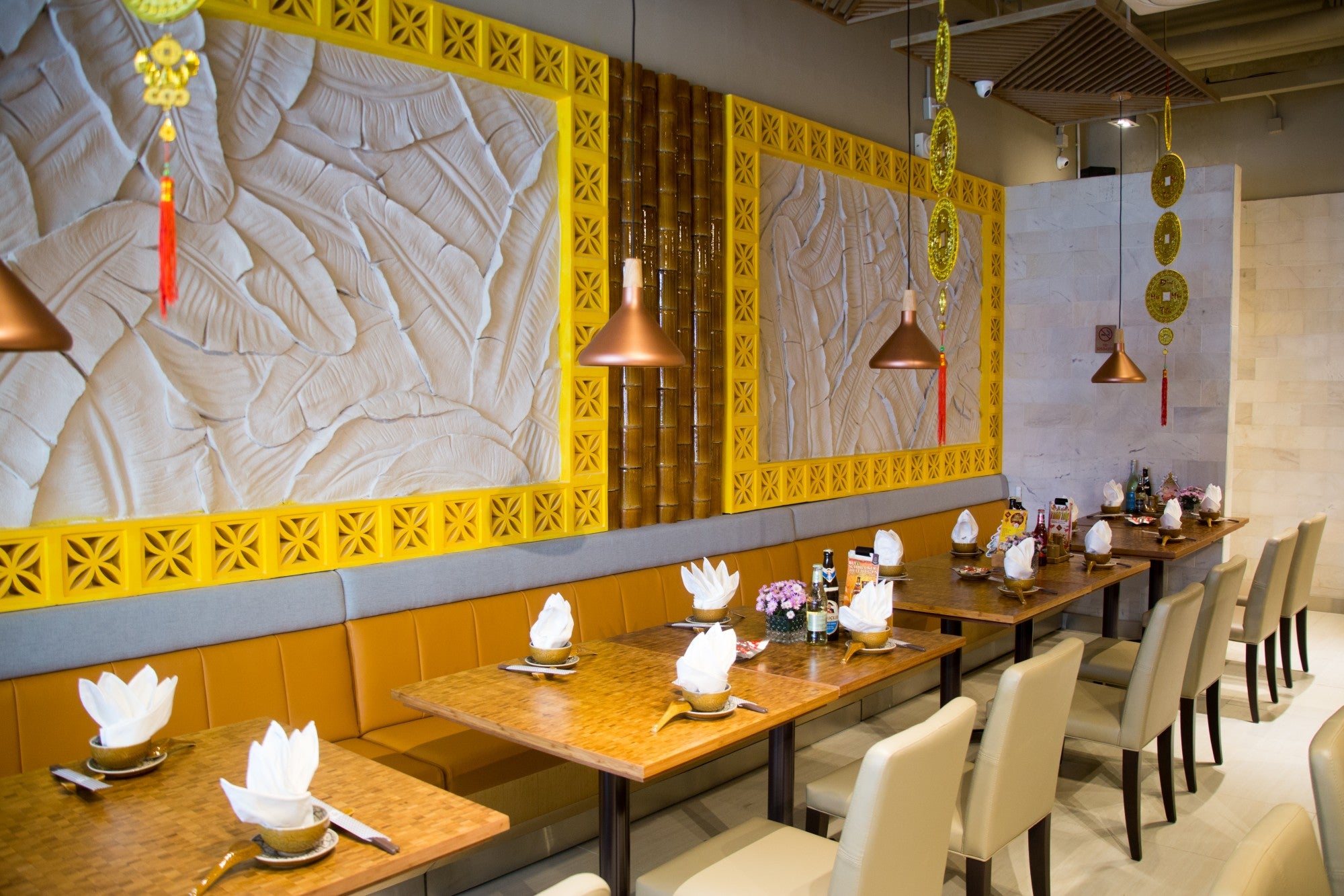 Beeza Sample by New York Cement Tile adds yellow decor and mid-century modern breeze blocks to a stylish restaurant interior.