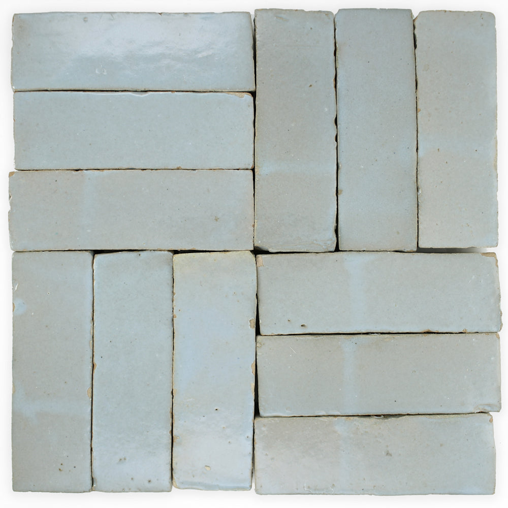 Arctic Blue (2x6) tiles by New York Cement Tile in a staggered basketweave on a white background.
