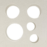Jami by New York Cement Tile features five unevenly clustered circular holes on a textured white surface, evoking breeze blocks.