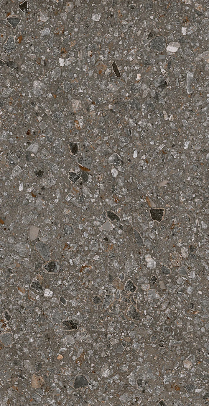 Close-up of Java - Perenne - Sample by New York Cement Tile, showcasing its gray, textured concrete and stone fragments.