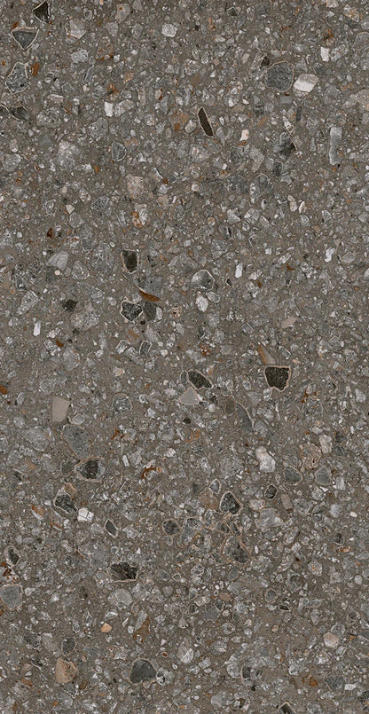 Close-up of Java - Perenne - Sample by New York Cement Tile, showcasing its gray, textured concrete and stone fragments.