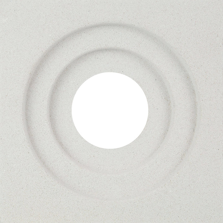 The Luzi Sample by New York Cement Tile features a textured white surface with two concentric grooves and a central hole.