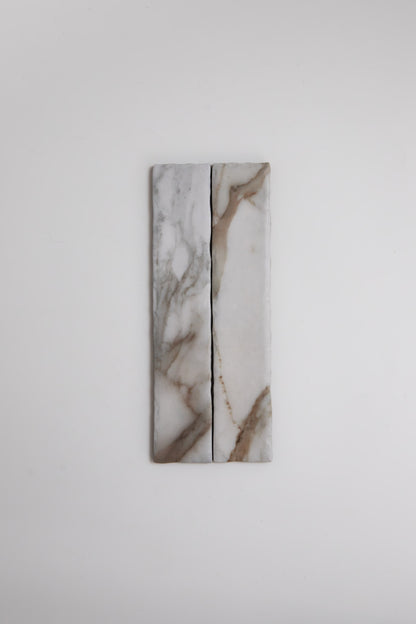 Two Tosca Macchia Vecchia Extra marble tile samples with gray and brown veins side by side on a white background.