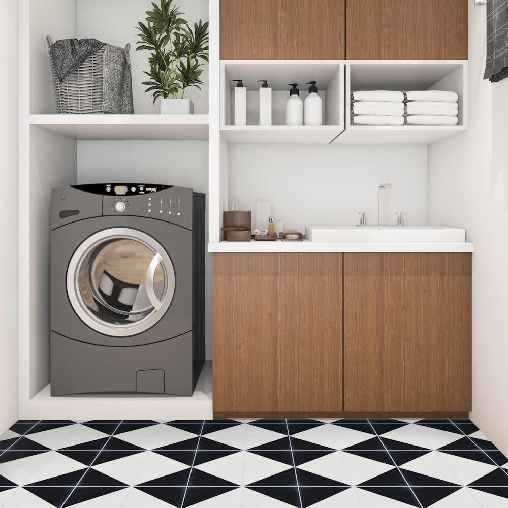 Modern laundry room with N20-139 Black & White tiles by New York Cement Tile, washer, sink, shelves, basket, and plant.