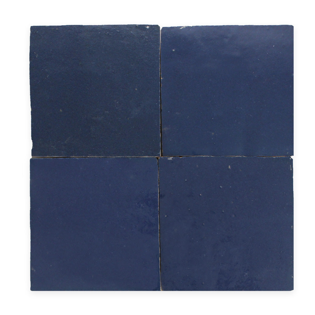 Four dark blue ceramic tiles arranged in a square grid on a white background.