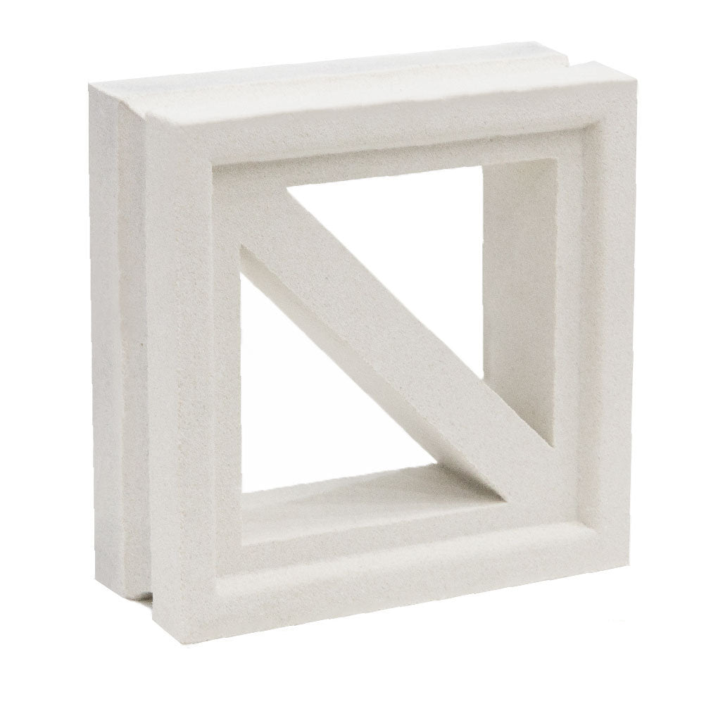 The Kaui by New York Cement Tile is a white square ventilation block with a diagonal bar—ideal for mid-century modern décor.