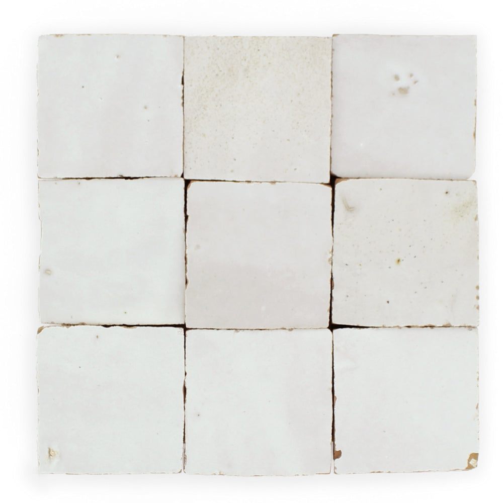 Nine Ivory Cloud 2X2 tiles by New York Cement Tile in a 3x3 grid, showing gentle imperfections and soft color shifts.