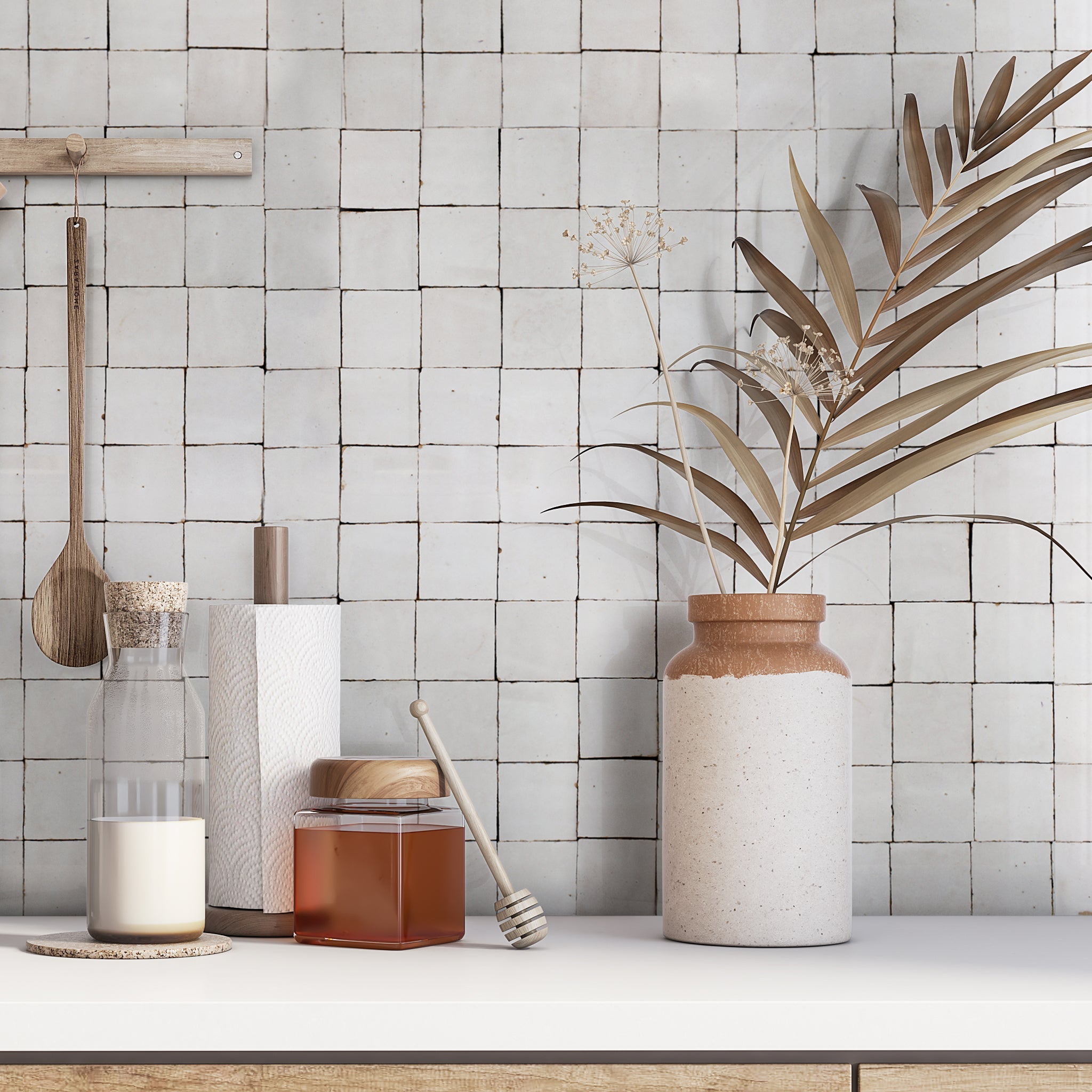 A kitchen counter with milk, honey, and utensils sits by a wall tiled in Ivory Cloud 2X2 by New York Cement Tile.