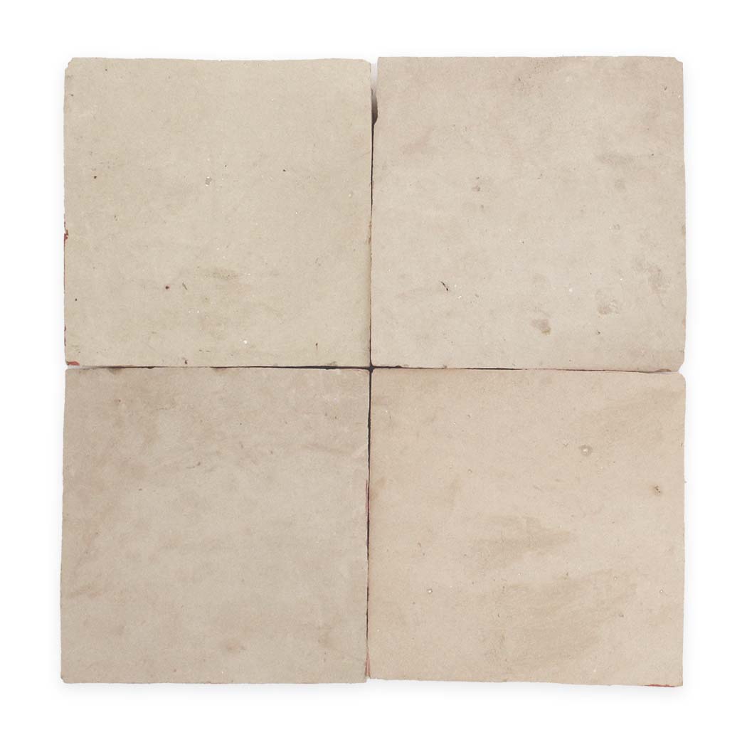 Four square, light beige tiles arranged in a 2x2 grid on a white background.