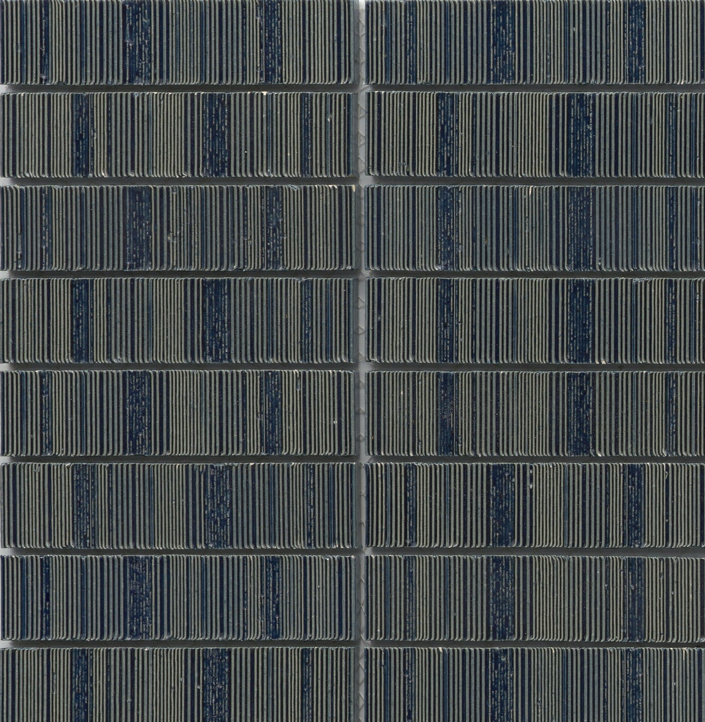 Close-up of Navy - Newtro - Sample by New York Cement Tile, arranged in a neat, geometric grid pattern.