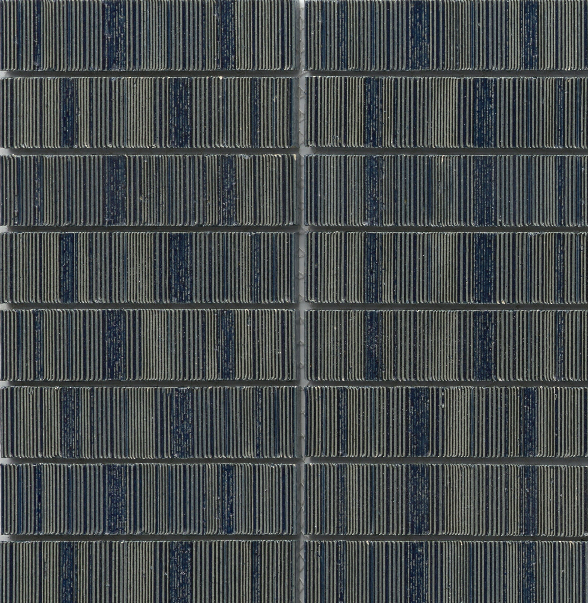 Close-up of Navy - Newtro - Sample by New York Cement Tile, arranged in a neat, geometric grid pattern.