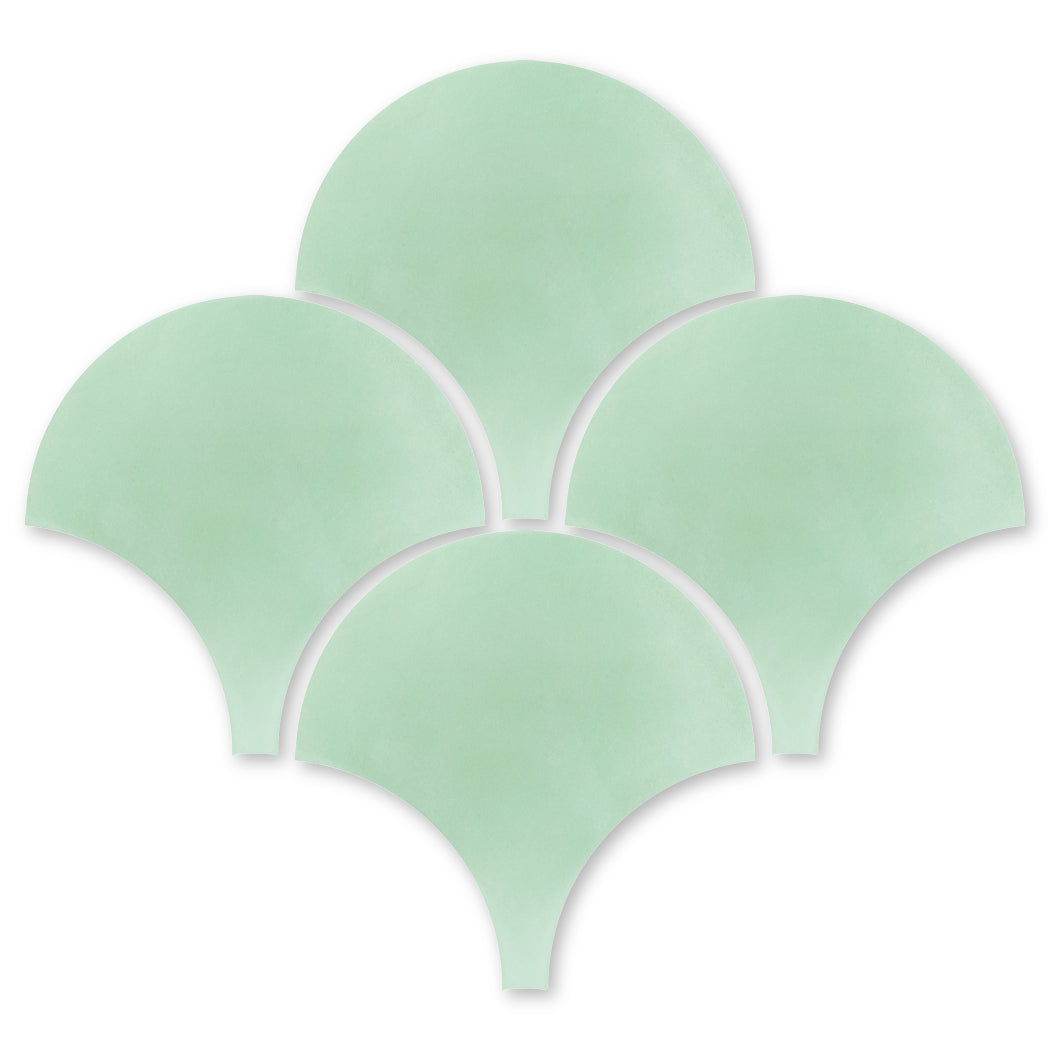 Five NF20-3300 Mint Fishscale tiles by New York Cement Tile overlap in a fan shape on a white background.