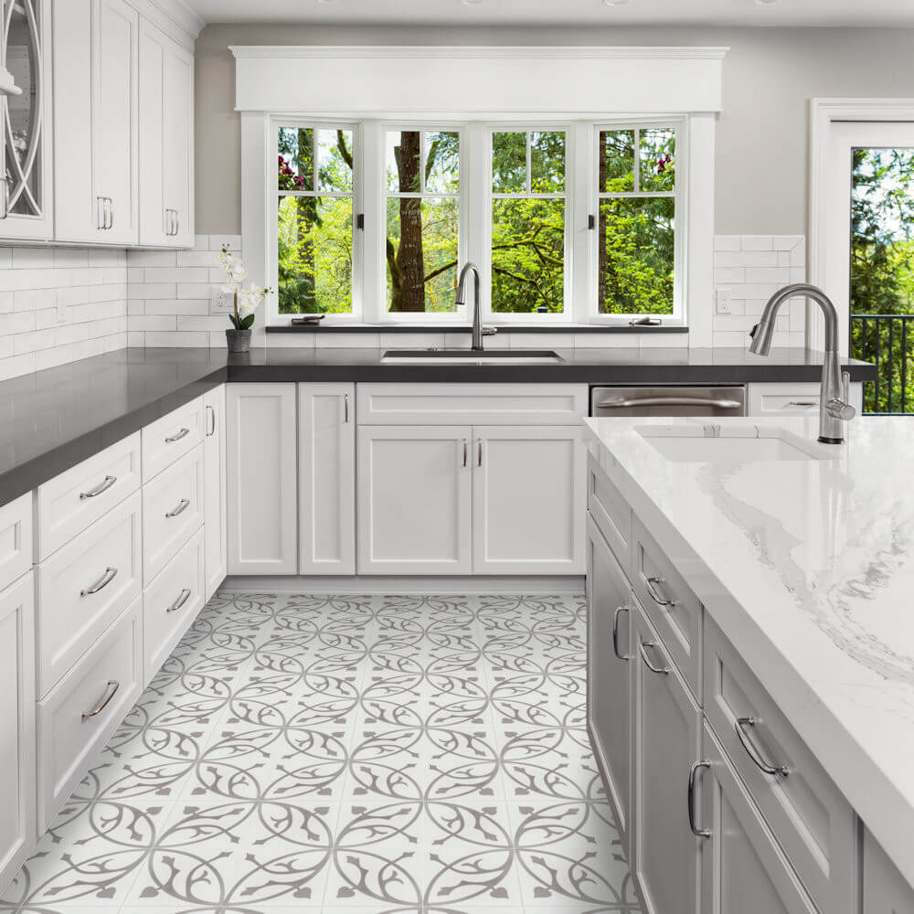 Modern white kitchen with N20-019 cement tiles by New York Cement Tile, gray counters & large windows facing trees.