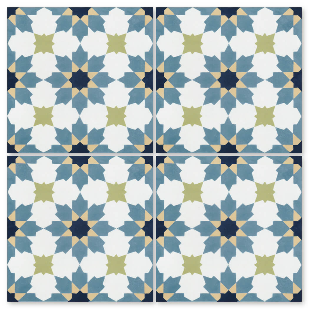Four N20-028 Navy Blue tiles by New York Cement Tile feature a geometric floral pattern in blue, white, olive green, and beige.