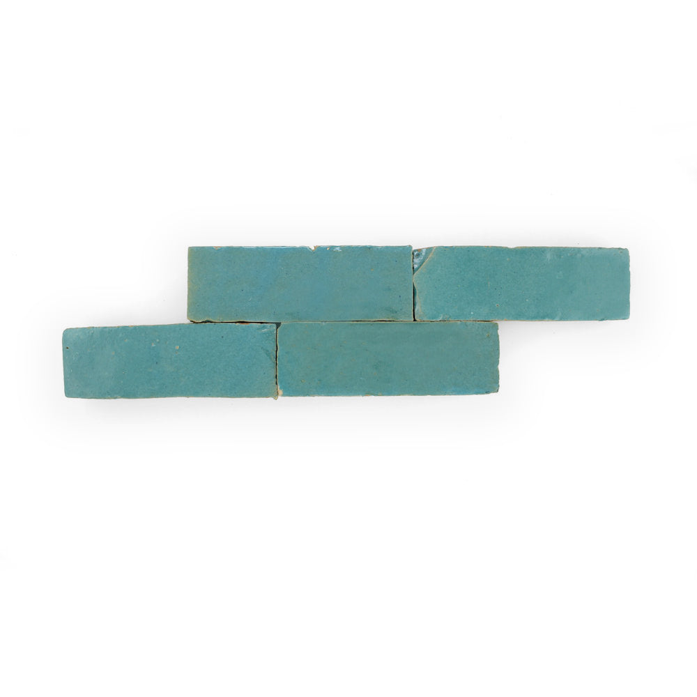 Four "Water line (2x6)" tiles by New York Cement Tile, turquoise, staggered and overlapping on a white background.