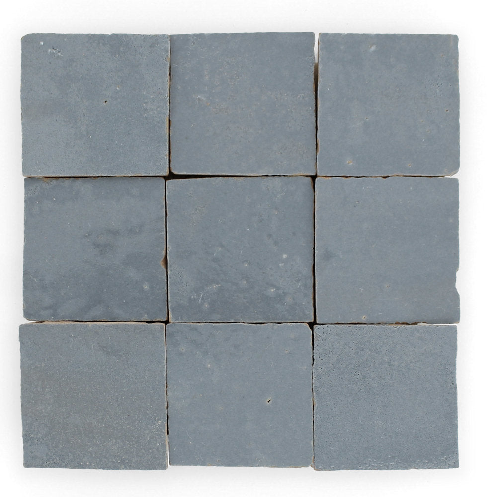 Nine Steel Grey tiles by New York Cement Tile arranged in a 3x3 grid on a white background.