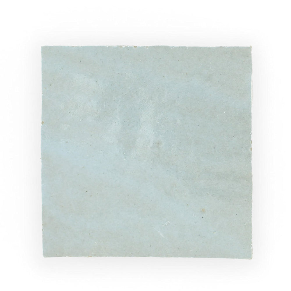 The Arctic Blue tile by New York Cement Tile is handcrafted, pale blue, with a soft matte finish and subtly uneven surface.