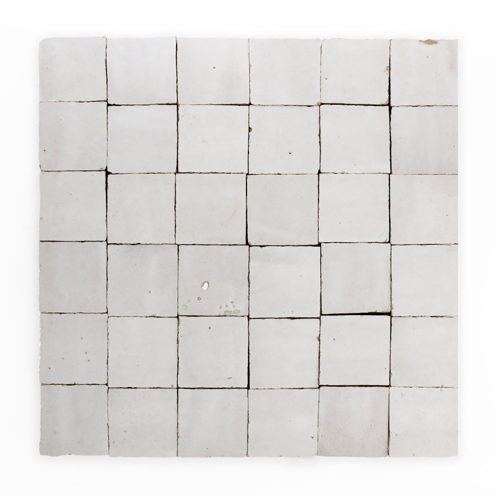 A grid of 36 Ivory Cloud 2X2 tiles by New York Cement Tile, with visible gaps and a subtly uneven white finish.