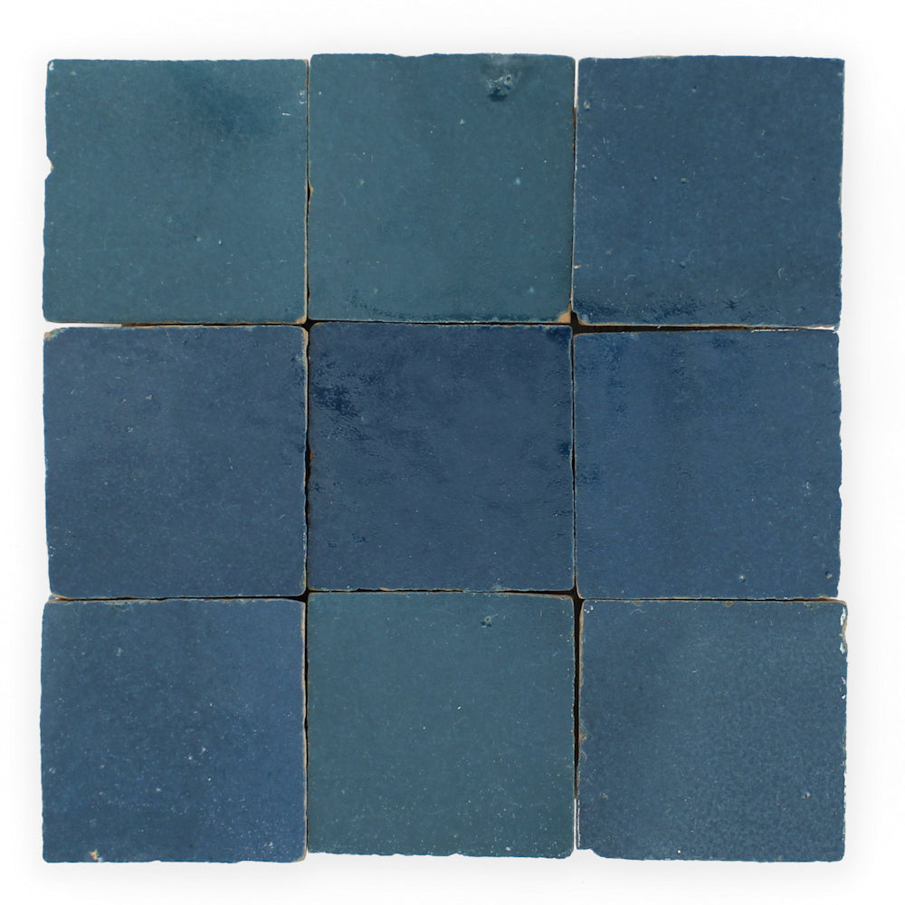 Sea Breeze by New York Cement Tile: nine square blue tiles in a grid, each with unique shades and handcrafted texture.