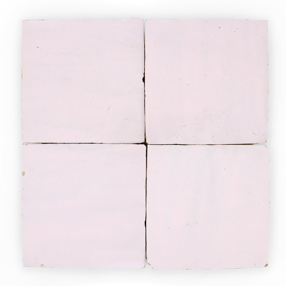 Four Rosy Pink 2x2 tiles from New York Cement Tile, arranged in a grid with slight gaps and handcrafted edges.