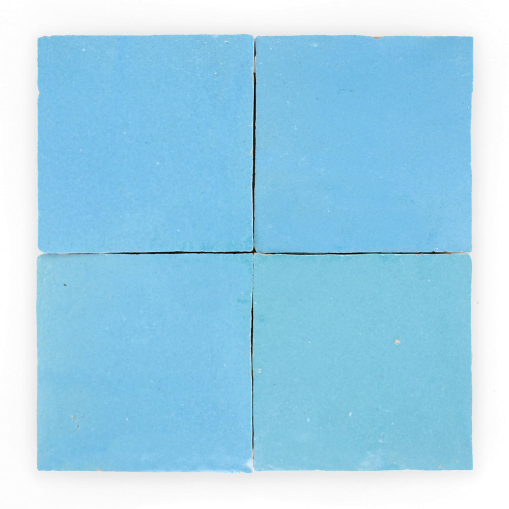 Four Azure 2X2 Extra Sample tiles by New York Cement Tile in a 2x2 grid on a white background.