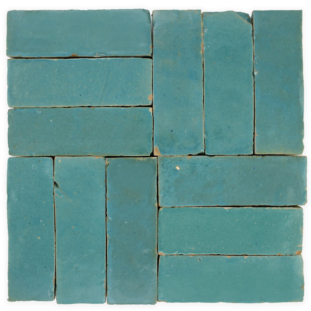 New York Cement Tile’s Water line (2x6) sample: blue rectangle tiles in herringbone pattern with visible seams, handcrafted.