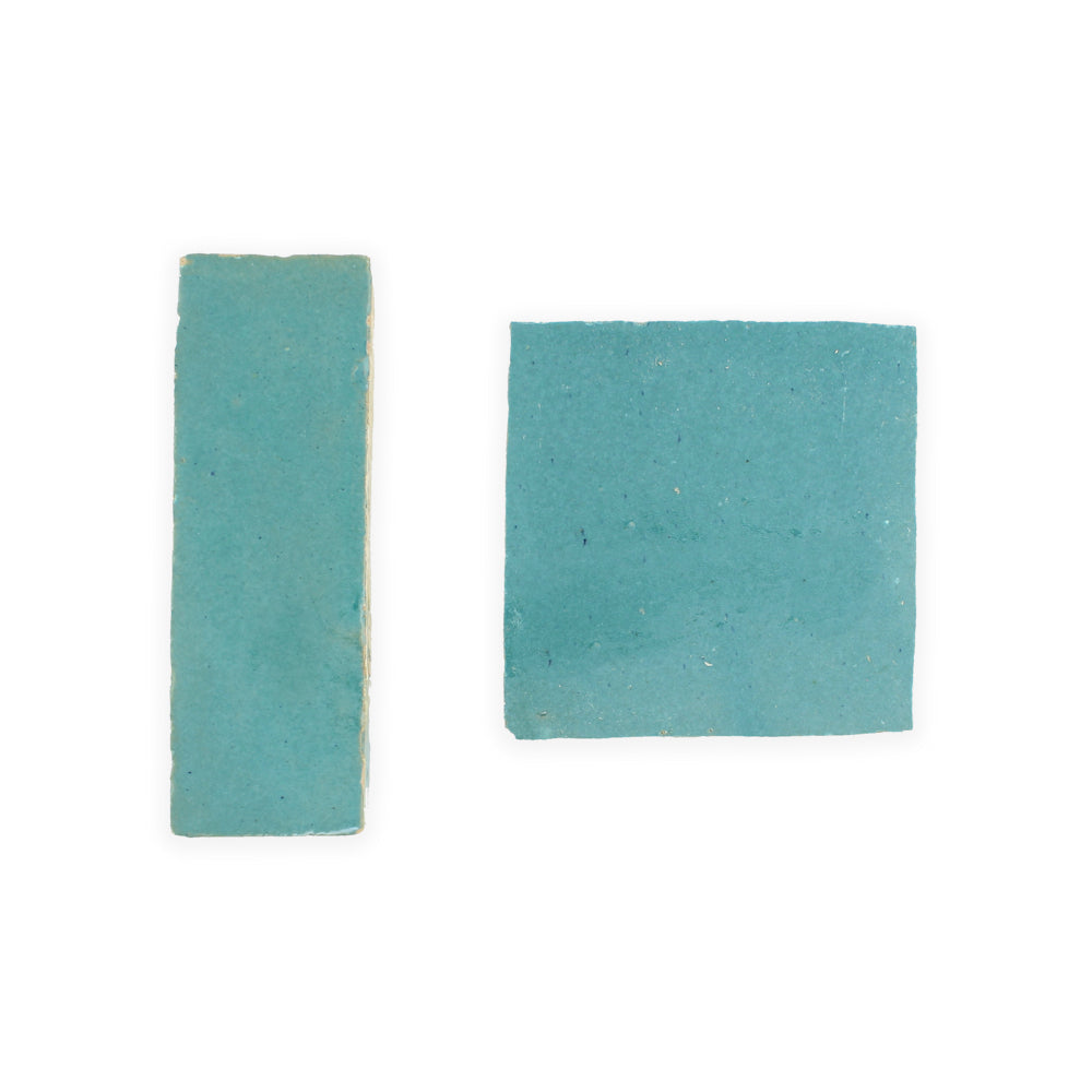 Two Water line 2X2 tiles by New York Cement Tile, side by side on a white background.