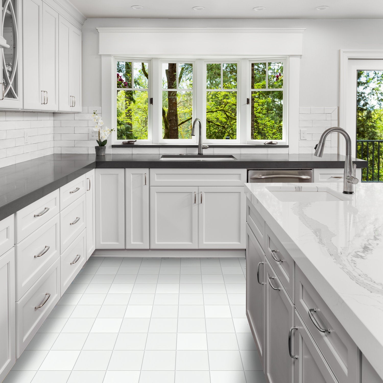 Modern kitchen featuring New York Cement Tile's 1100-Solid White 8x8 and marble island, overlooking green trees.