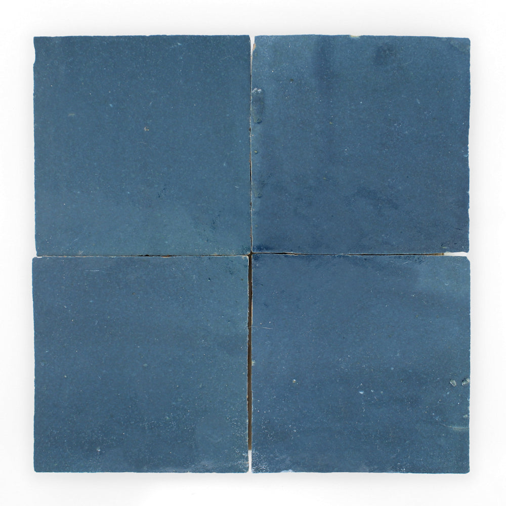 Four Sea Breeze 2x2 tiles by New York Cement Tile, handcrafted in blue, arranged in a grid on a white background.
