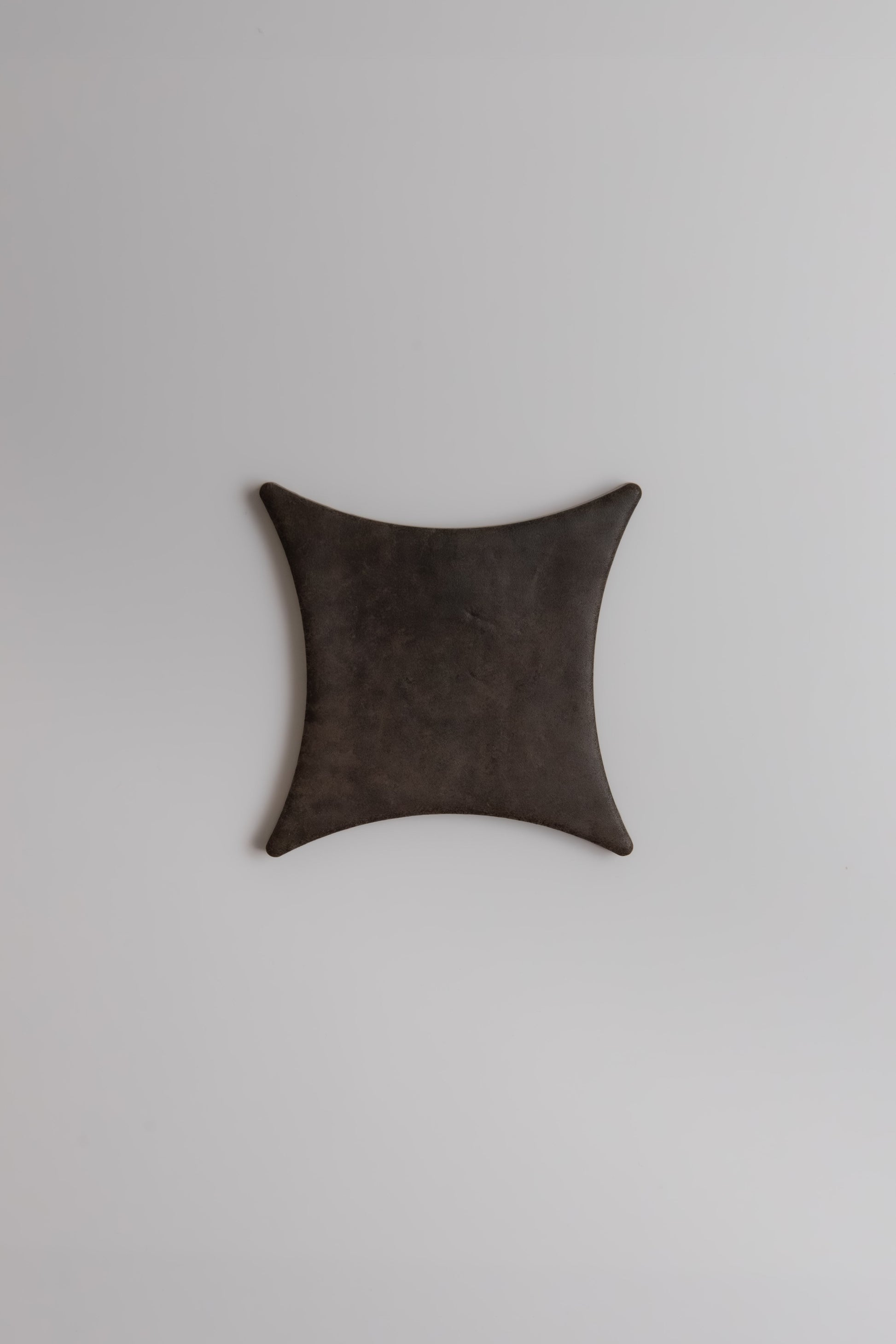 The Ocre, Extra Sample by Finca is a black, square leather tray with curved sides on a plain light gray background.