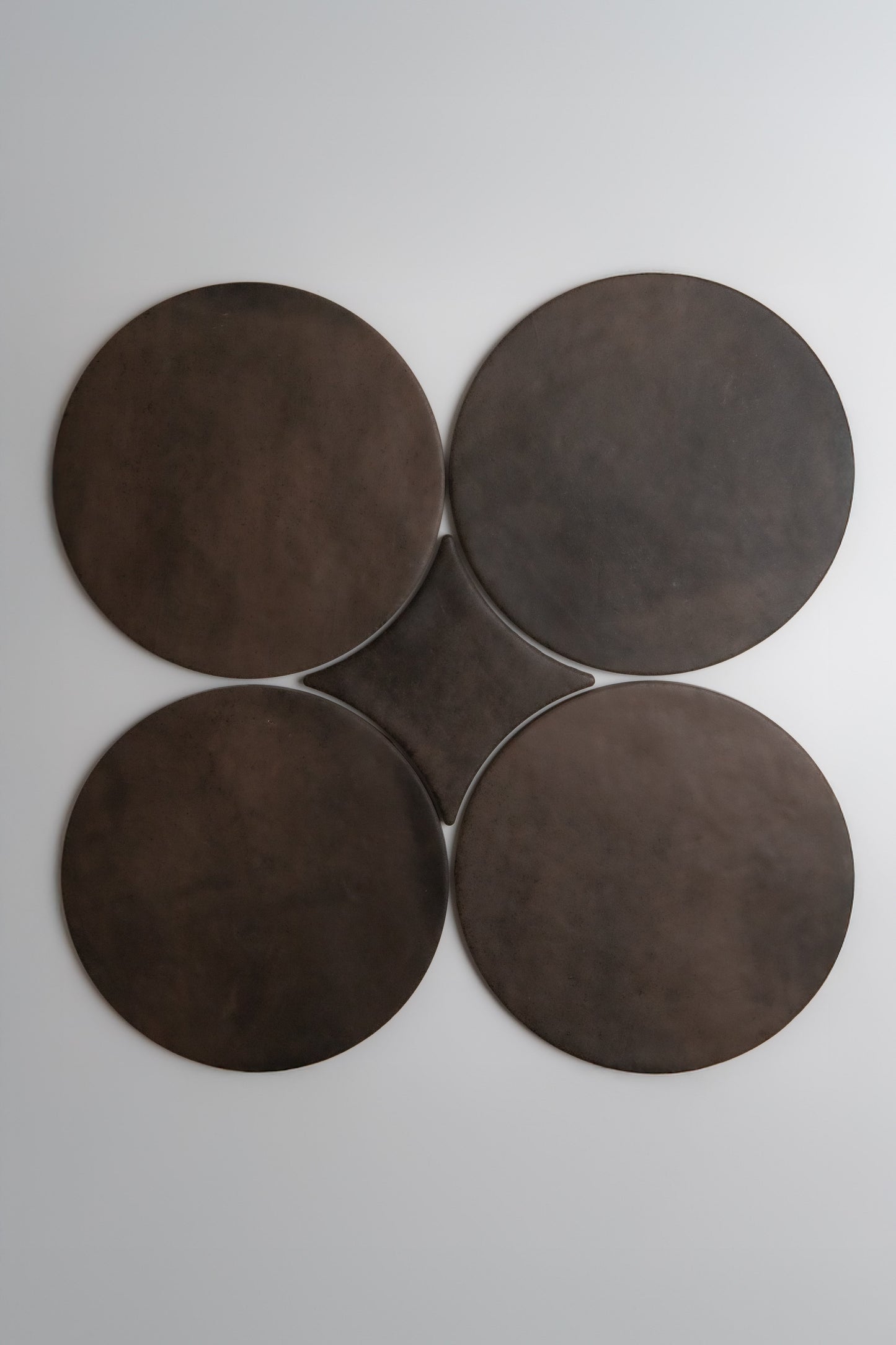 Four large Finca Ocre, Extra Sample disks are arranged in a clover shape on a plain white background.