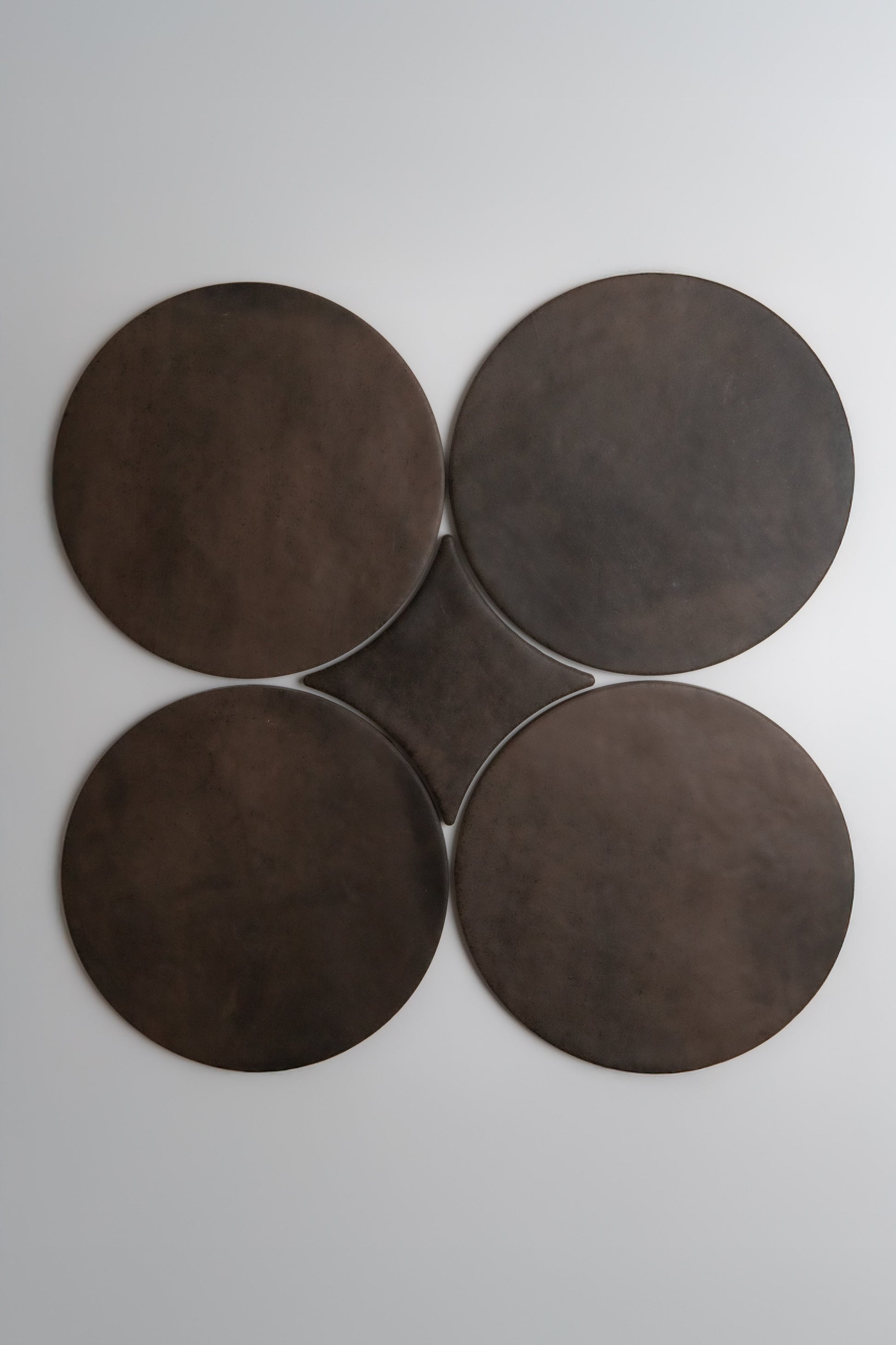 Four large Finca Ocre, Extra Sample disks are arranged in a clover shape on a plain white background.