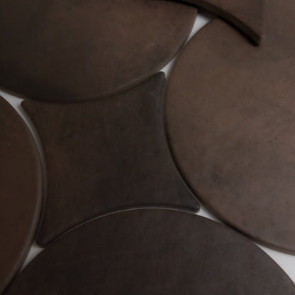 Finca’s Ocre, Extra Sample features overlapping round and square brown surfaces with smooth, matte textures.