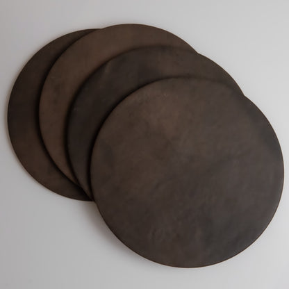 Four round Ocre, Extra Sample discs by Finca overlap on a light gray surface.