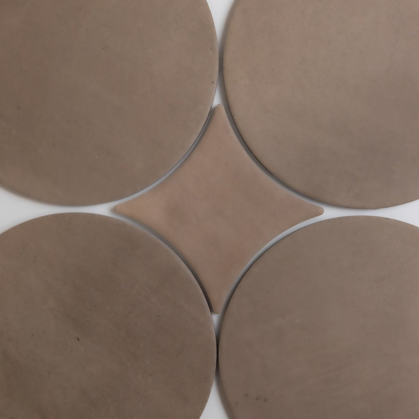 Four large tan circles surround a central diamond on a white background in the Pampas design by Finca.