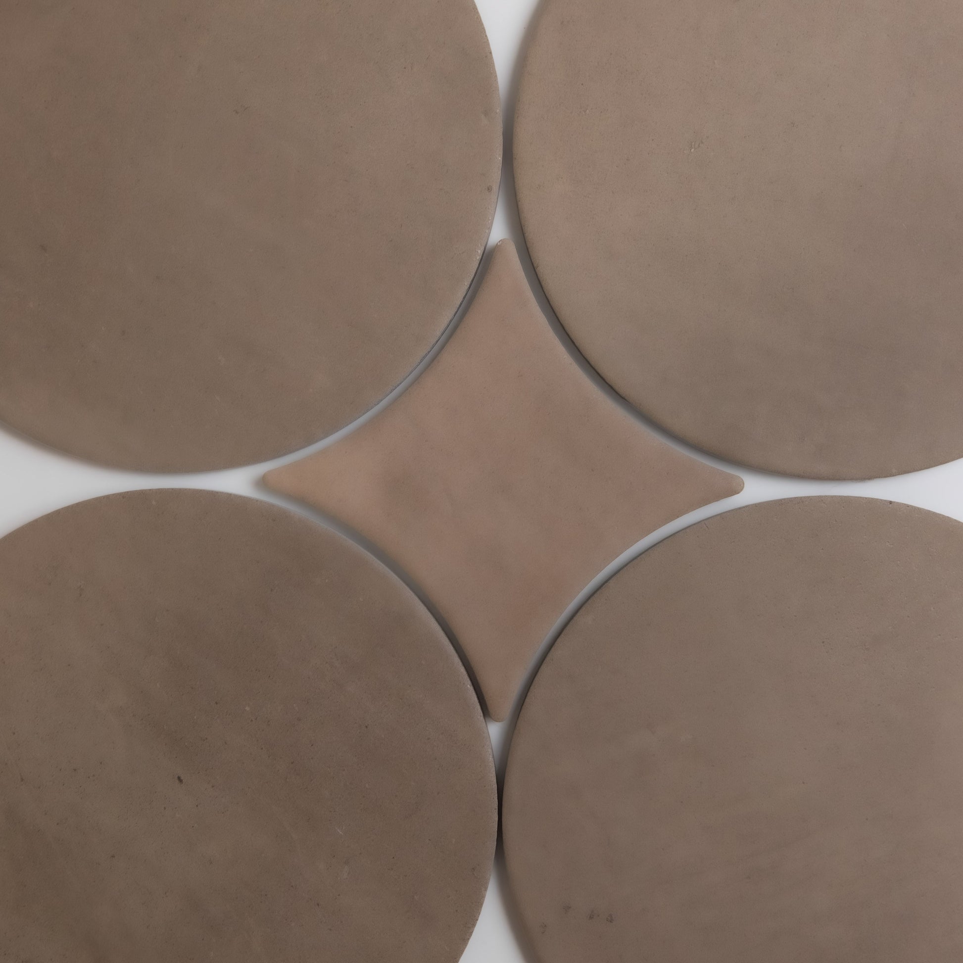 Four large tan circles surround a central diamond on a white background in the Pampas design by Finca.