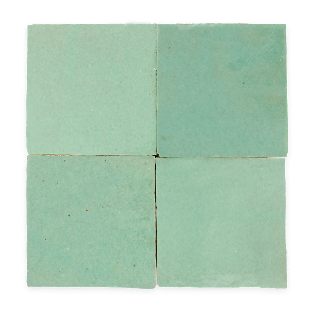 Four square, light turquoise tiles arranged in a two-by-two grid on a white background.