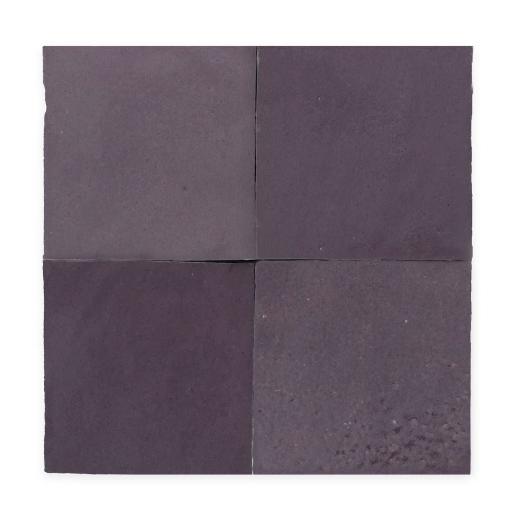Four square, dark purple ceramic tiles arranged in a two-by-two grid against a white background.
